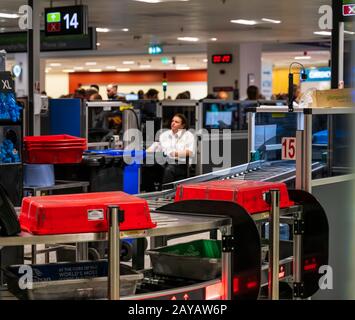 Dublin, Ireland, May 2019 Dublin airport Terminal 1, hand luggage scanning, officers inspecting bagg Stock Photo