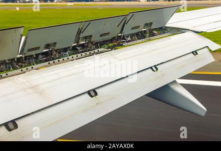 view of the spoiler uprising during a landing of an airliner Stock Photo