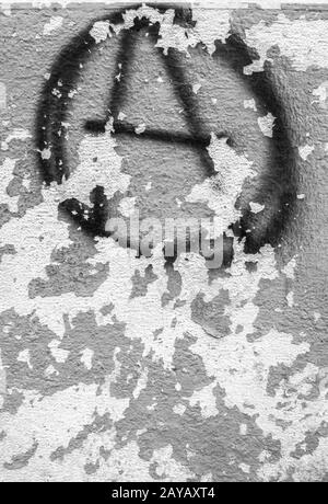 Symbol of anarchy painted on the peeling old wall Stock Photo