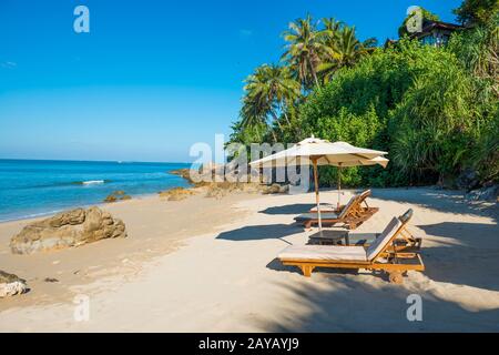 Pair of deck chairs at tropical beach Stock Photo