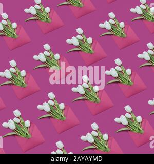 Decorative background with gift envelopes of tulips flowers on a magenta. Stock Photo