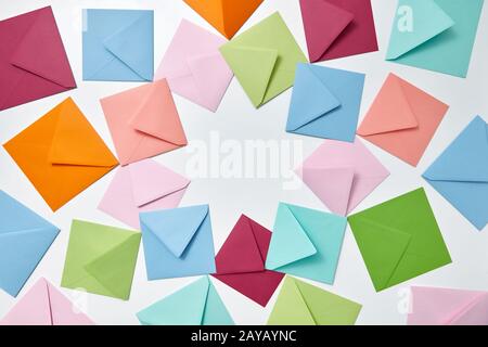 Colorful frame from empty handmade envelopes on a light background. Stock Photo