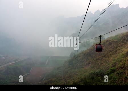 Cable way vanishing in mist or fog in Tianmen Mountain Stock Photo