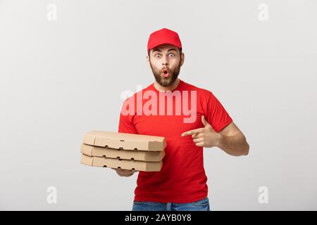 Delivery Concept: Portrait of Pizza delivery man presenting something in box. Isolated white background. Stock Photo