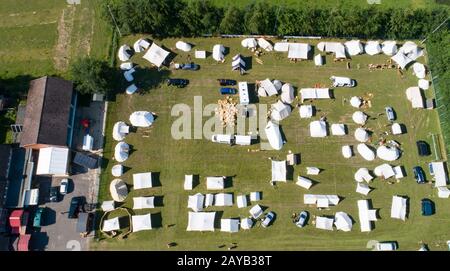 Aerial view of a tent camp and market stalls at a medieval spectacle ...
