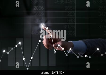 Businessman hand touching rising economy graph on virtual screen - business, financial investment success concepts hand point ne Stock Photo