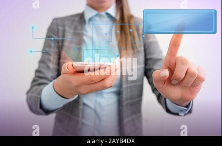 Businesswoman with finger touching text box holding digital tablet whilst standing. Lady front presenting hand blue glow copy sp Stock Photo