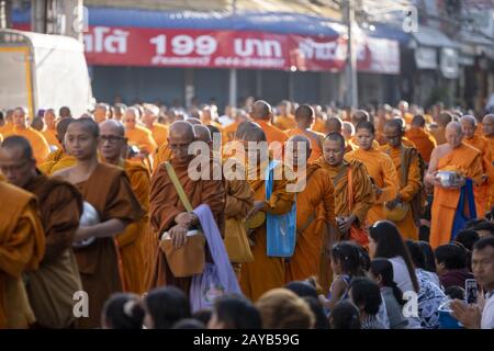Korat, Nakhon Ratchasima, Thailand. 15th Feb, 2020. 10,000 monks gathered in Korat's Suan Rak Park to take part in a massive alms giving ceremony to remember the victims of the mass shooting in the city that claimed 30 lives. In addition to honoring the victims of the shooting members of the public brought food and supplies to give as donations to the monks in order to make merit in the Buddhist tradition. Credit: Adryel Talamantes/ZUMA Wire/Alamy Live News Stock Photo