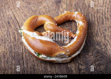 Bavarian pretzel with butter on wood Stock Photo