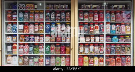 jars of old fashioned traditional british sweets in on display in the window of a shop Stock Photo