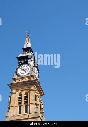 the ornate clock tower of the historic 19th century atkinson building in southport merseyside against a blue summer sky Stock Photo