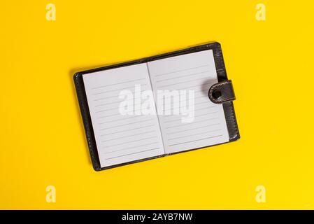 Close front view private dark leather locked diary with striped paper sheets color background. Useful writing down secrets plann Stock Photo