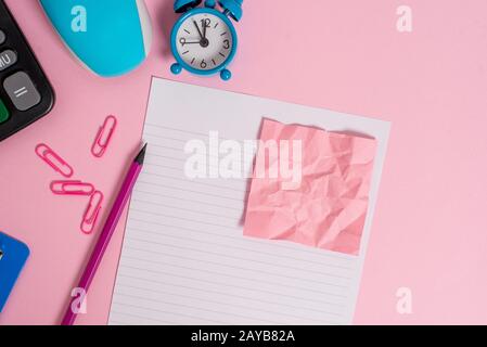 Portable electronic calculator clips wire mouse clipboard alarm clock wakeup pencil crushed note striped letter size sheet color Stock Photo