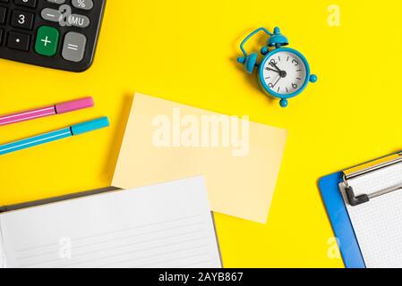 Empty orange paper with copy space on the yellow table. Blank paper for text messages. Business concept with blank papers on the Stock Photo