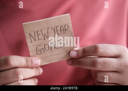 new year goals written on notepad, close up  Stock Photo