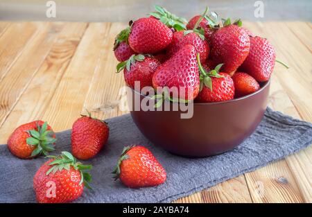 Strawberries on the table in a ceramic bowl. Stock Photo