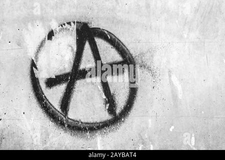 Symbol of anarchy painted on the peeling old wall Stock Photo