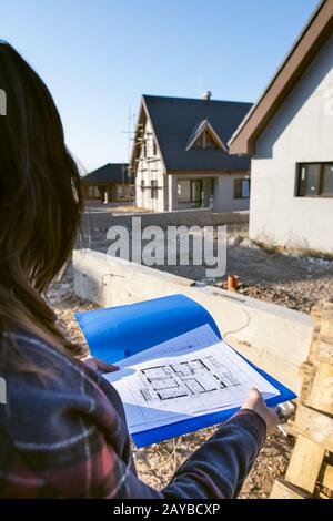 New build house and blueprints Stock Photo