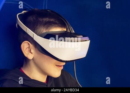 Child watching movie with VR glasses. Special effects. Technology and entertainment concept with virtual reality glasses. Stock Photo