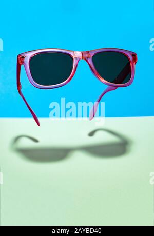 Sunglasses On Blue Background Stock Photo - Alamy