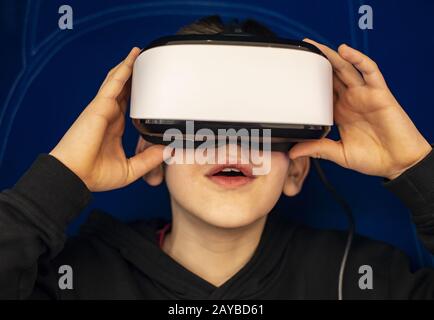 Child watching movie with VR glasses. Special effects. Technology and entertainment concept with virtual reality glasses. Stock Photo