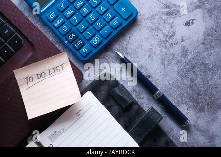 to do list on notepad with laptop and calculator on desk  Stock Photo