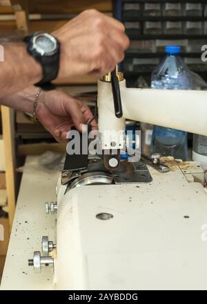Tailor process leather in workshop. Stock Photo