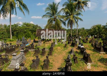 A cemetery next to rice fields on Java Island in Indonesia. Stock Photo