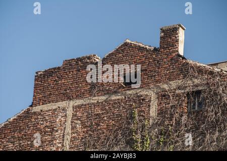 Backside old weathered vintage brick building wall facade Stock Photo