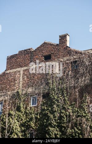Backside old weathered vintage brick building wall facade Stock Photo
