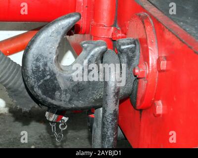 coupling hook from an old steam locomotive painted black on red buffers Stock Photo