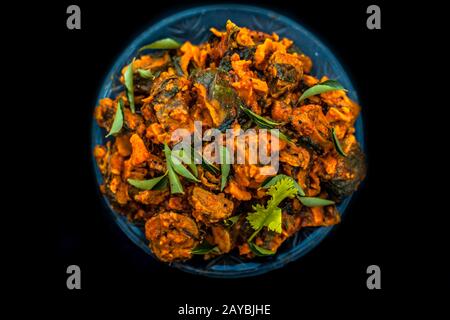 Famous Indian & Gujarati snack dish in a glass plate on wooden surface i.e. Patra or paatra consisting of mainly Colocasia esculenta or arbi ke pan or Stock Photo