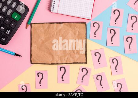 Math stuff with scribbled and crumbling papers plus writing equipment on coloured backdrop. Stationary, cardboards with notation Stock Photo