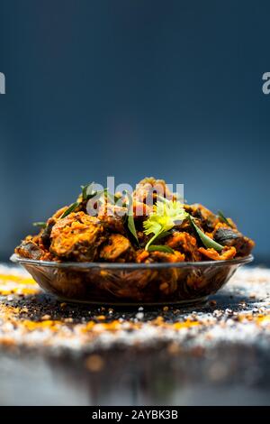 Famous Indian & Gujarati snack dish in a glass plate on wooden surface i.e. Patra or paatra consisting of mainly Colocasia esculenta or arbi ke pan or Stock Photo