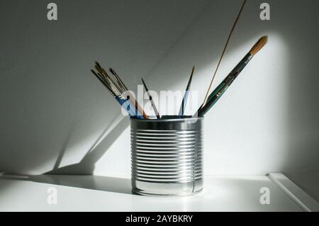 Tin can with paint brushes Stock Photo