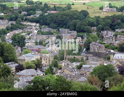 an aerial view of the town of hebden bridge with streets and houses surrounded by summer trees and fields Stock Photo