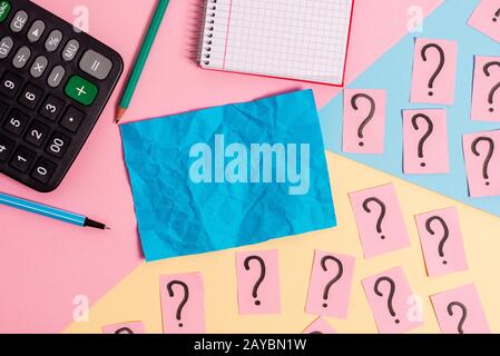 Math stuff with scribbled and crumbling papers plus writing equipment on coloured backdrop. Stationary, cardboards with notation Stock Photo
