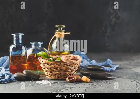 Natural macadamia oil in a glass bottle with macadamia nuts Stock Photo