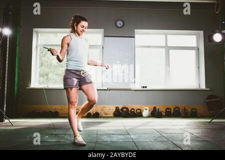 Young Caucasian smiling woman holding a skipping rope - Health and Fitness Concept
