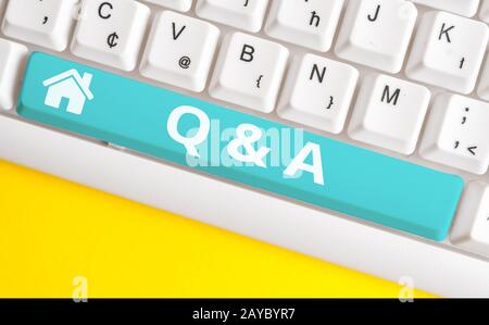 Text sign showing Q And A. Conceptual photo defined as questions being asked and answers White pc keyboard with empty note paper Stock Photo