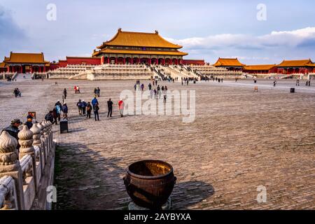 Multiple tourists visiting Forbidden City, front view on central square and temples Stock Photo