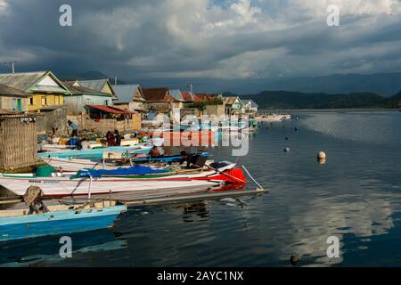 Fishing boats at the Bajau Sea Gypsy village on Bungin Island, famous for living in stilt houses above the water and living entirely off the sea, off Stock Photo