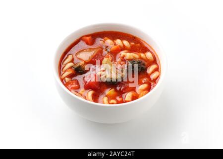 minestrone vegetables tomato soup with pasta closeup isolated on white background Stock Photo