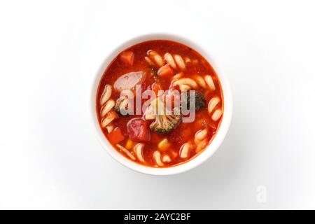 minestrone vegetables tomato soup with pasta closeup isolated on white background Stock Photo