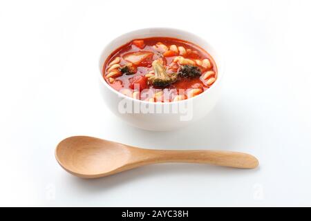 minestrone vegetables tomato soup with pasta closeup isolated on white background Stock Photo