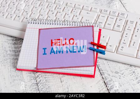 Word writing text Hello I Am New. Business concept for introducing oneself in a group as fresh worker or student notebook paper Stock Photo