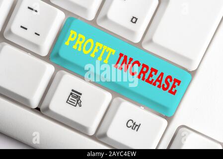 Text sign showing Profit Increase. Conceptual photo the growth in the amount of revenue gained from a business White pc keyboard Stock Photo