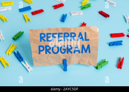 Text sign showing Referral Program. Conceptual photo employees are rewarded for introducing suitable recruits Colored clothespin Stock Photo