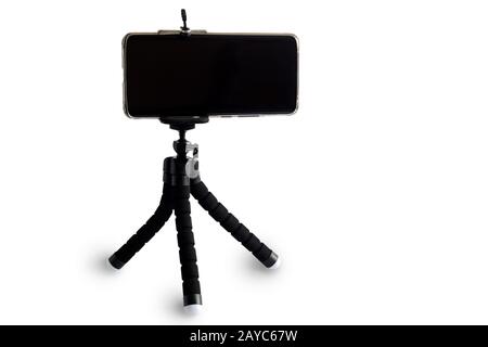 Smartphone and smartphone tripod on white background. Stock Photo