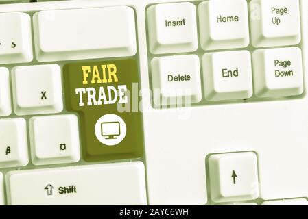 Text sign showing Fair Trade. Conceptual photo Small increase by a analysisufacturer what they paid to a producer White pc keybo Stock Photo